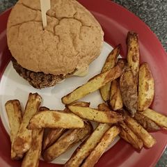 A picture of Cheese Burger and chunky chips.