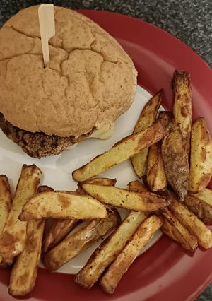 A picture of Cheese Burger and chunky chips.