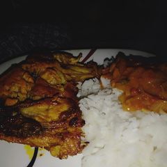 A picture of Marinated chicken, served with coconut sauce n rice.