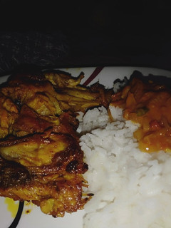 A picture of Marinated chicken, served with coconut sauce n rice.