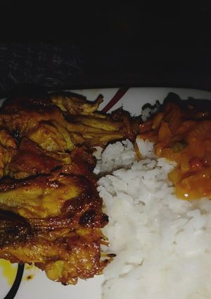 A picture of Marinated chicken, served with coconut sauce n rice.