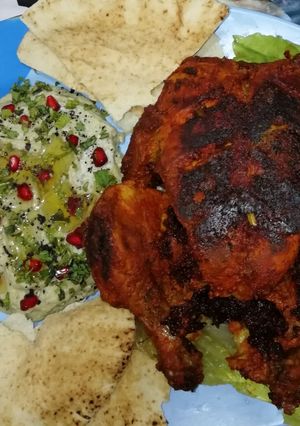 A picture of Chicken tandoori with moutabel(spicy eggplant dip).