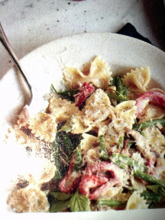 A picture of Farfalle alfredo with sausage.