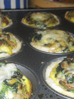 A picture of Swiss, bacon and spinach mini quiches.