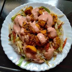 A picture of Bbq chicken served with fried rice.