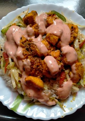 A picture of Bbq chicken served with fried rice.