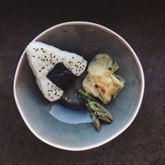 A picture of Onigiri with soy seared asparagus.