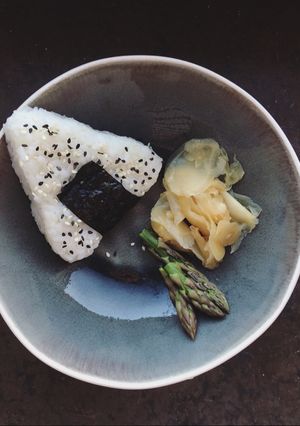 A picture of Onigiri with soy seared asparagus.