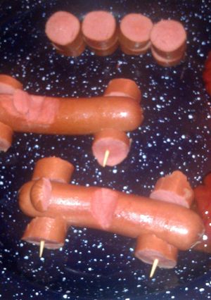 A picture of hotdogs race cars.