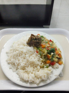 A picture of White rice with curry sauce.