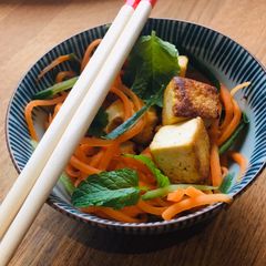 A picture of Tofu stir fry in Ponzu dressing and fresh mint.