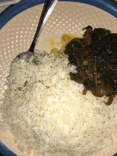 A picture of Rice with ugu soup.