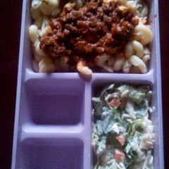 A picture of Macaroni bolognais with coleslaw.