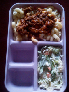 A picture of Macaroni bolognais with coleslaw.