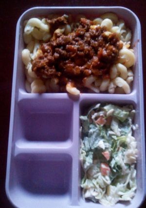 A picture of Macaroni bolognais with coleslaw.