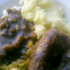 A picture of Sausages, Mashed potatoes with gravy.
