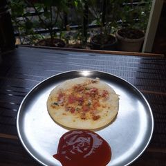 A picture of Onion tomato uttapam.