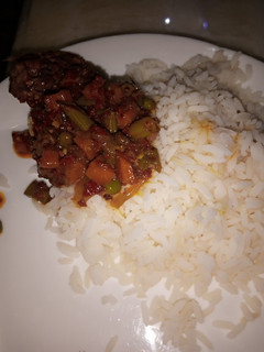 A picture of White rice with vegetables soup.
