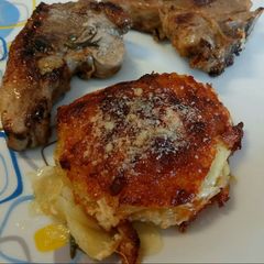 Parmesan and rosemary potato gratin with pan fried lamb A picture of Parmesan and rosemary potato gratin with pan fried lamb.