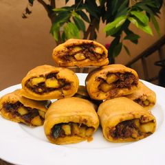 A picture of Potatoes and fish rolls.