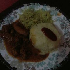 A picture of Chicken curry with mashed potatoes.