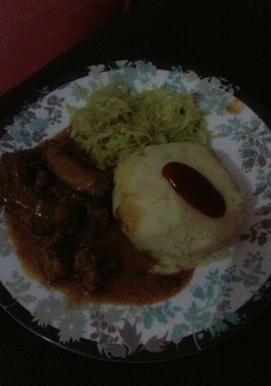 A picture of Chicken curry with mashed potatoes.