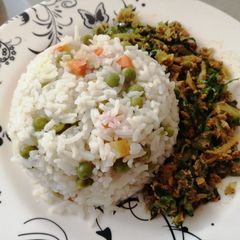 A picture of Vegetable rice with egg fried cabbage.