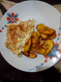 A picture of Fried plantain with fried eggs.