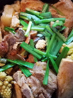 A picture of Pork neckbone cauliflower tofu stew.