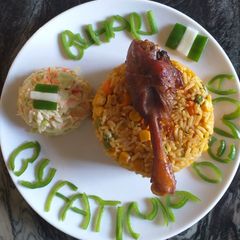 A picture of Jollof Rice with vegetables.