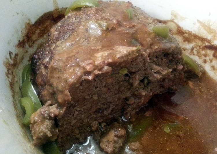 meatloaf with brown gravy topped with bellpeppers