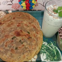 A picture of Lachha paratha with mint buttermilk.