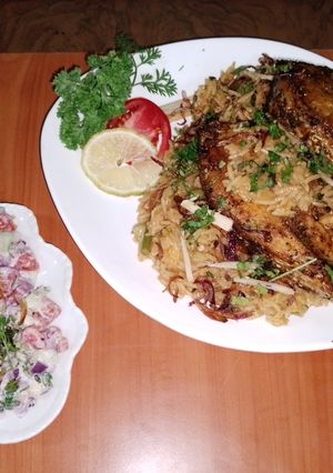A picture of Fish vegetable biryani 🐟🥕🧅🍅🍋🧄and yoghurt kachumbari 🥗.