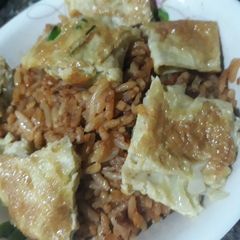 A picture of Jollof rice and fried egg.