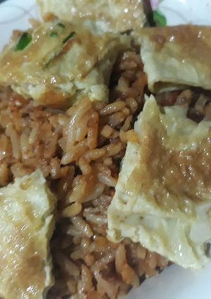 A picture of Jollof rice and fried egg.