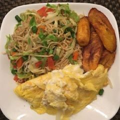 A picture of Indomine with fried plantain,fried egg and vegetables.