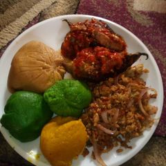 A picture of Coloured moi moi with pepper fish and scramble eggs.
