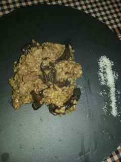 Una foto de Risotto de setas, panceta y parmesano