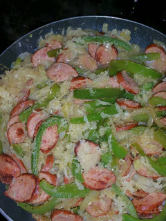 A picture of Bratwurst with Bell Peppers and Sauerkraut.