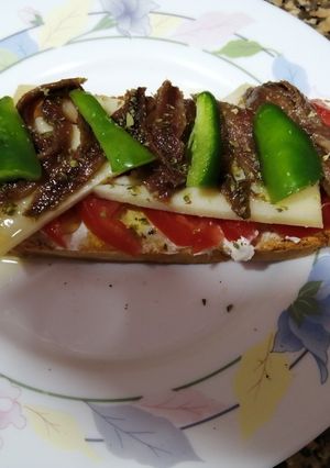 A picture of Light Dinner: Toasted Bread Slice with Manchego Cheese and Anchovies.