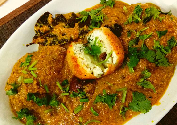 Aloo kofta with paneer stuffing in golden gravy