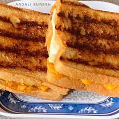 A picture of Grilled Schezwan Aloo cheese sandwiches.