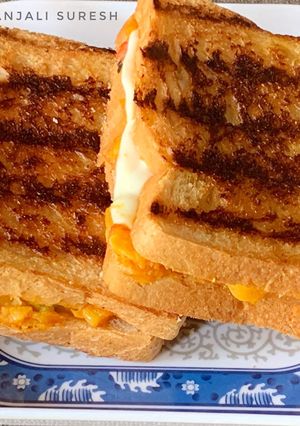 A picture of Grilled Schezwan Aloo cheese sandwiches.