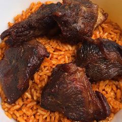 A picture of Jollof rice with fried chicken.