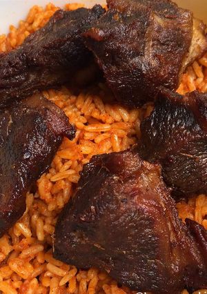 A picture of Jollof rice with fried chicken.