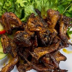 A picture of Lemongrass Saté Butter Quail.