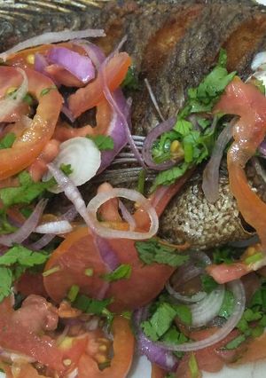 A picture of Fried fish with kachumbari.
