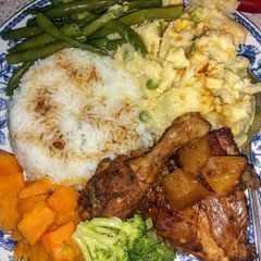 A picture of Homestyle chicken, mashed potatoes, candied yams and veggies.