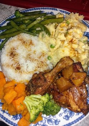 A picture of Homestyle chicken, mashed potatoes, candied yams and veggies.