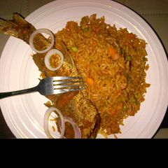 A picture of Jollof rice and fried fish.